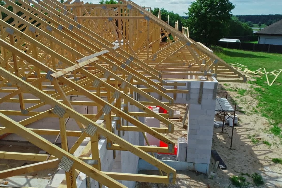 House framing under construction on a residential lot for an article about whether you can use VA loan for land in Texas