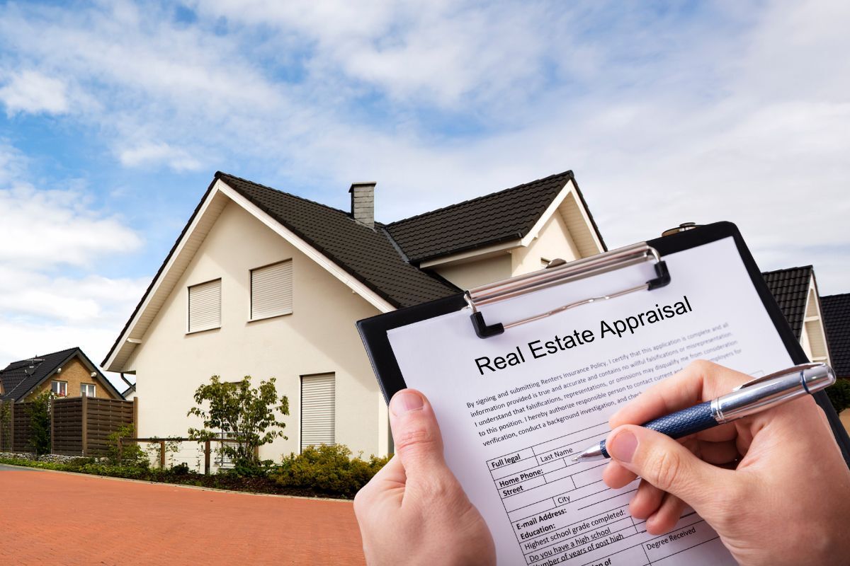 Person filling out a real estate appraisal form in front of a modern suburban home under a clear blue sky.