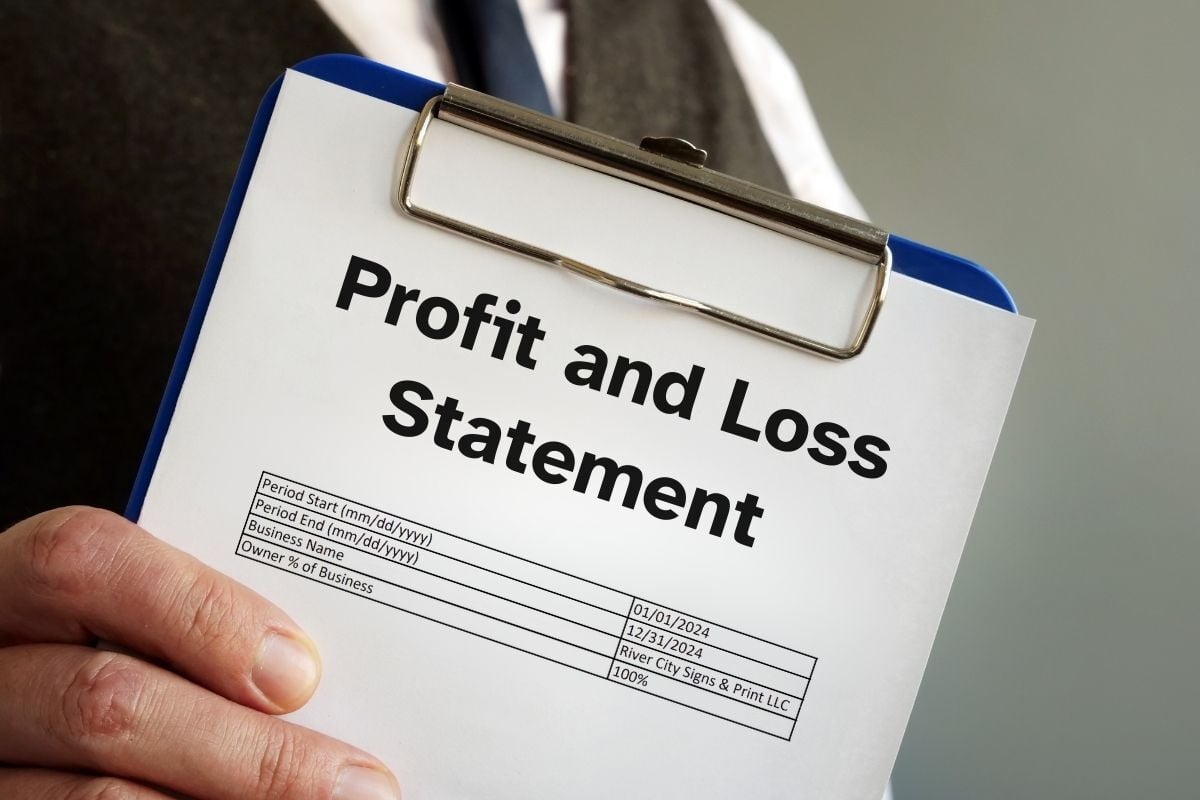 Business owner holding a profit and loss statement